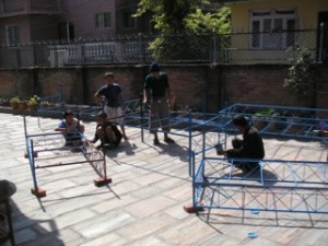 The bed frames being assembled in the front yard