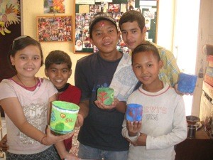 The children showing off the pape mache pots they made in school