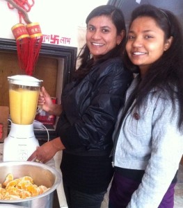 Pramila and Bhagvati make fresh fruit juice for the children